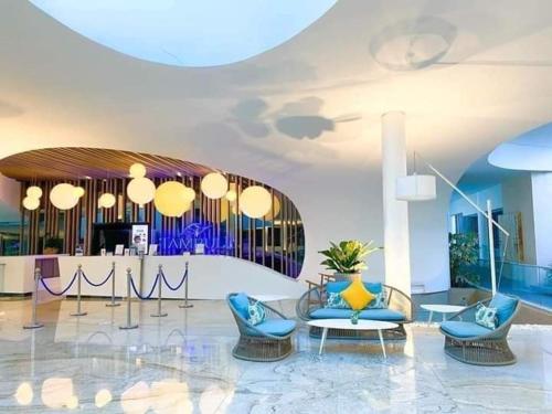 a lobby with chairs and a table and a bar at Tambuli Resort Tower D in Lapu Lapu City