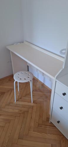 a desk and a stool in a room with a table at Aurora with the view in Rijeka