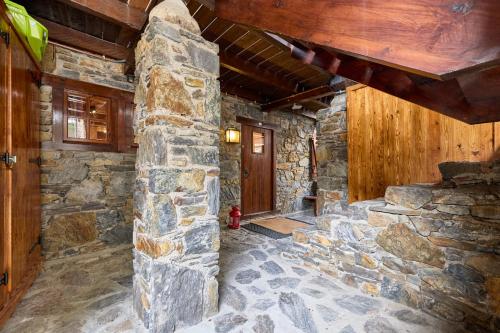 a room with a stone wall and a fire hydrant at Pleta del Tarter 31A Lodge & SPA HUT 8254 in Canillo