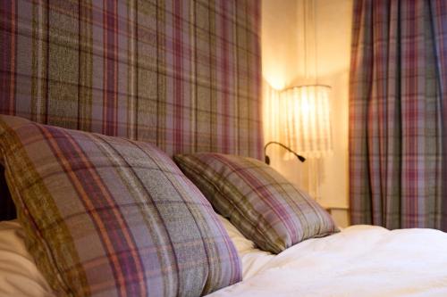 a bed with two pillows on top of it at Pleta del Tarter 31A Lodge & SPA HUT 8254 in Canillo
