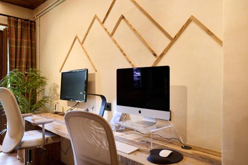 a desk with a computer and two monitors on it at Pleta del Tarter 31A Lodge & SPA HUT 8254 in Canillo