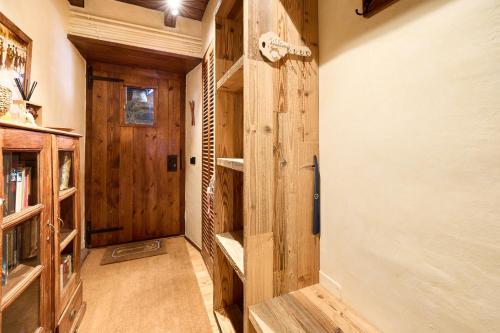 a hallway with wooden walls and a door with shelves at Pleta del Tarter 31A Lodge & SPA HUT 8254 in Canillo