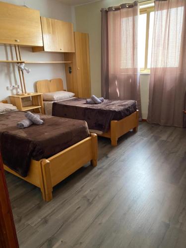 a bedroom with two beds and a window at Swieqi 3 bedroom apartment in St. Julianʼs