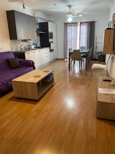 a living room with a couch and a table at Swieqi 3 bedroom apartment in St. Julianʼs