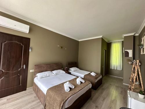 a bedroom with two beds with towels on them at WoodSea in Batumi