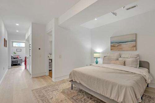 a white bedroom with a large bed in it at Suite in the heart of downtown Toronto in Toronto