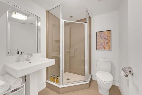 a bathroom with a shower and a toilet and a sink at Suite in the heart of downtown Toronto in Toronto