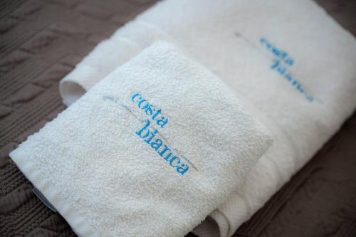 a towel with the words guest bathrooms written on it at Costa Bianca Villas in Koilás