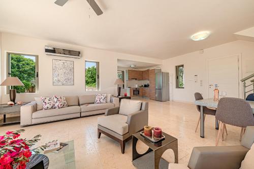 a living room with a couch and a table at Costa Bianca Villas in Koilás