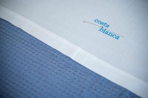 a white envelope with the words coaster blanket at Costa Bianca Villas in Koilás