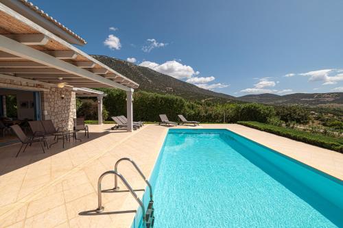 a swimming pool with a view of a mountain at Costa Bianca Villas in Koilás