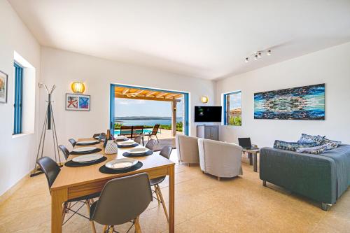 a living room with a table and a couch at Costa Bianca Villas in Koilás