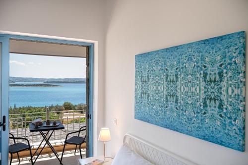 a bedroom with a large blue painting on the wall at Costa Bianca Villas in Koilás