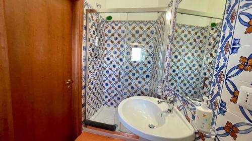 a bathroom with a sink and a shower at Residenza Porta di Mare in Castellabate