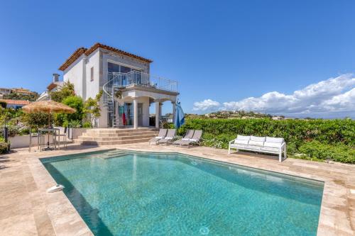 a villa with a swimming pool and a house at Stunning Sea View Cote d'Azur Villa - Rives d'Or in Fréjus