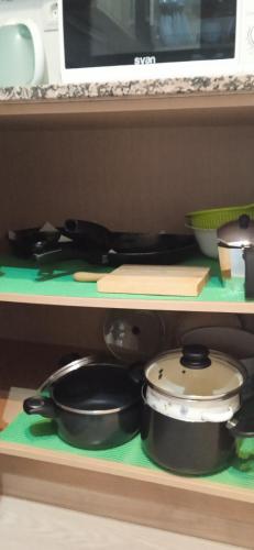 a shelf with some pots and pans on it at Bonito bajo cerca del mar in Benicarló
