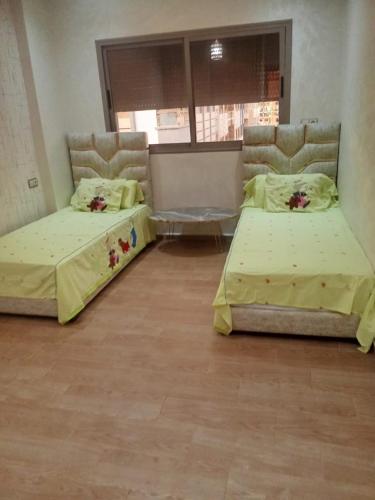 two beds sitting in a room with at بوزنيقة in Bouznika