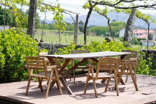 a wooden picnic table and chairs on a patio at Casa da Eira by Quantique in Amares