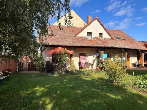 a house with a grass yard in front of it at Ferienwohnung Am Schwielochsee in Schwielochsee