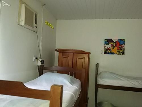 Säng eller sängar i ett rum på Residencial Dom Luiz