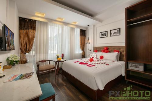 a hotel room with a large bed with red decorations on it at Victory Legend Hotel - In Hanoi Central in Hanoi