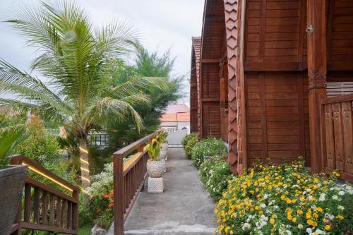 a walkway next to a building with flowers at Innora Jungle Resort And Spa in Nusa Penida