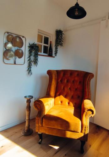 a yellow chair sitting in a corner of a room at Villa Schöneck Bad Münster in Bad Kreuznach