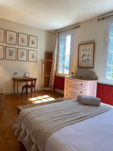 una camera con letto, cassettiera e tavolo di La Maison Reverdi a Lamarque