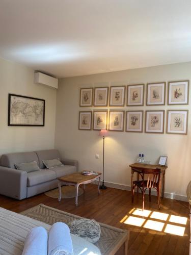 a living room with a couch and a table at La Maison Reverdi in Lamarque