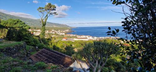 a view of a town and the ocean from a hill at Adega Melo Pereira - 2 quartos com vista mar in São Roque do Pico