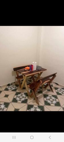 a wooden picnic table sitting on a tiled floor at Casa de mar in La Libertad