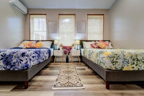 two beds in a room with two windows at The Little Villa - 2Bed 1Bath Private Suite in Bristol