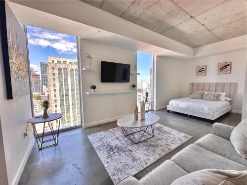 a living room with a couch and a tv at Luxe Loft Heart of Miami Brickell Downtown in Miami