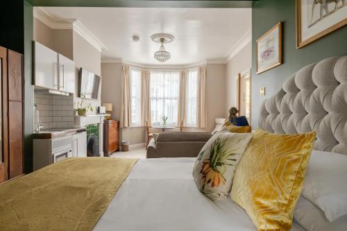 a living room with a bed and a couch at Deco Studio: King bed, kitchenette, stylish & comfortable in Brighton & Hove