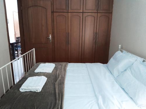 a bedroom with a bed with two towels on it at Spartan Townhouse Apt 3 Leonidas in Sparti