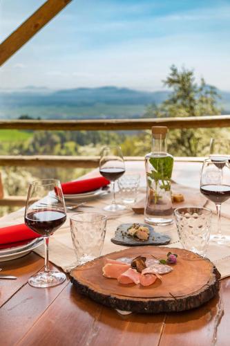a table with wine glasses and a plate of food at Pr' Končovc in Kranj