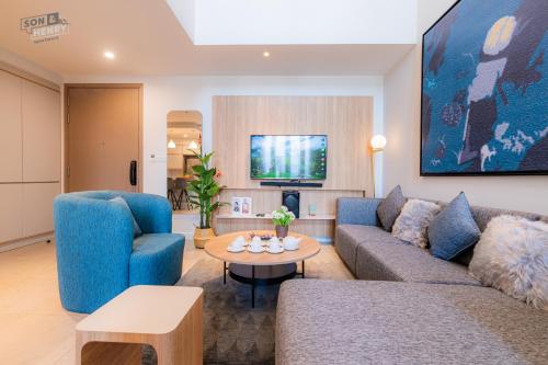 a living room with a couch and a table at Son&Henry Zenity District 1 in Ho Chi Minh City