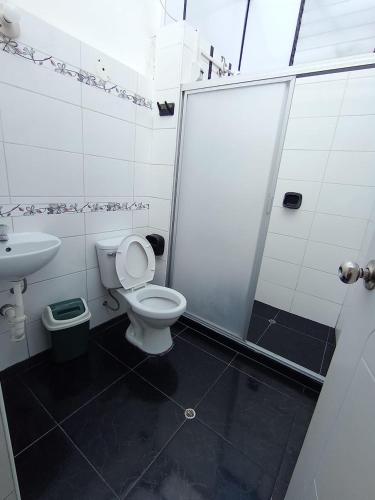 a bathroom with a shower and a toilet and a sink at HOSTAL La RASA in Cusco