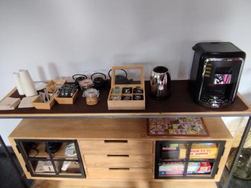a shelf with a coffee maker and other items on it at Casa Rural La Comella in Tirvia