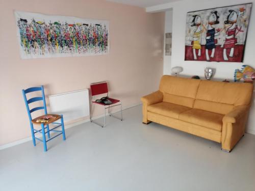 un salon avec un canapé et une chaise dans l'établissement grand studio La Rochelle, à La Rochelle