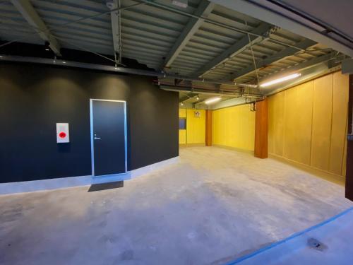 an empty room with a blue door on the wall at My Home Inn Sennan, Onosato in Ozaki