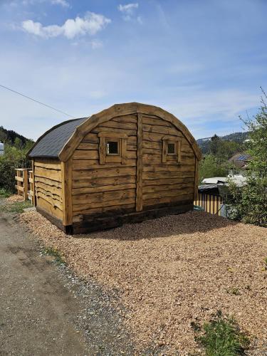 a large wooden building sitting on top of gravel at Wolpertinger | Camping-Aach in Oberstaufen