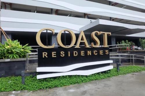 a sign in front of a building that reads coast residence at Luxury Condo with a view of Manila Bay in Manila