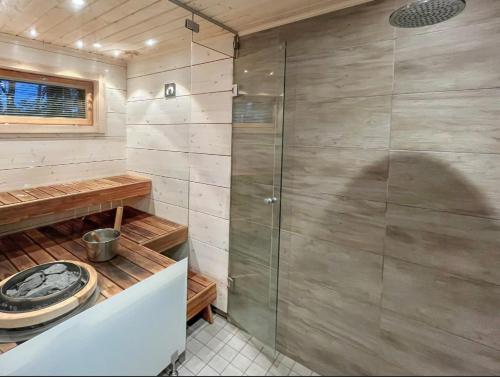 a shower with a glass door in a bathroom at Villa Paadar in Inari