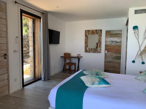 a bedroom with a white bed with pillows on it at VILLA MACAGNA in Corbara