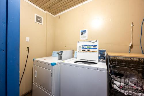 a laundry room with a washing machine next to a refrigerator at LEMONADE SOL in Tempe