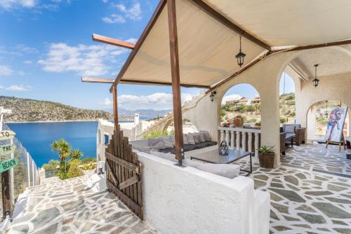 an outdoor patio with a view of the ocean at Villa Corali in Pefkali