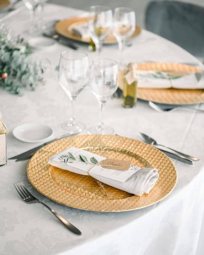a table with a plate with napkins and wine glasses at Solar das Bouças by Quantique in Amares