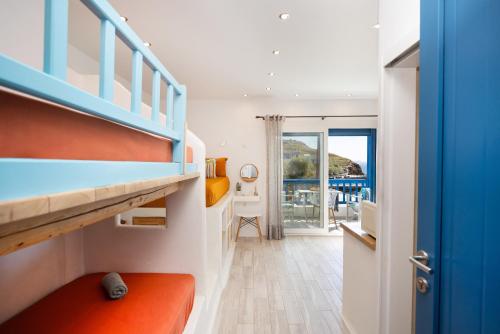 a bedroom with a bunk bed with an orange seat at Bella Vista Mare in Moutsouna Naxos