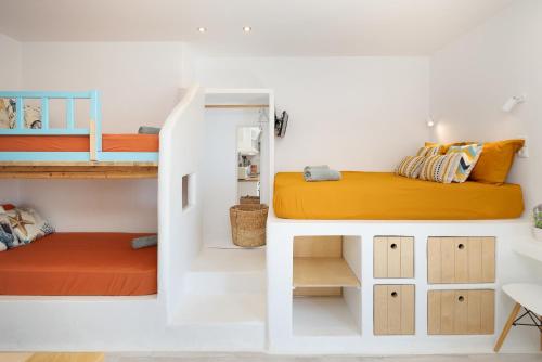 a room with two bunk beds and a desk at Bella Vista Mare 1 in Moutsouna Naxos